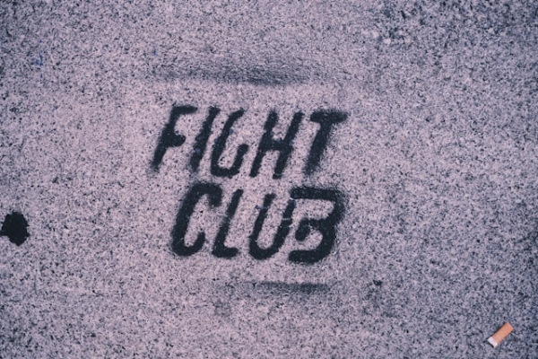 Fight Club stencil on concrete. Photo by Claudio Schwarz on Unsplash