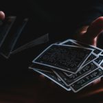Playing cards being shuffled in hands. Photo by Sergi Viladesau on Unsplash