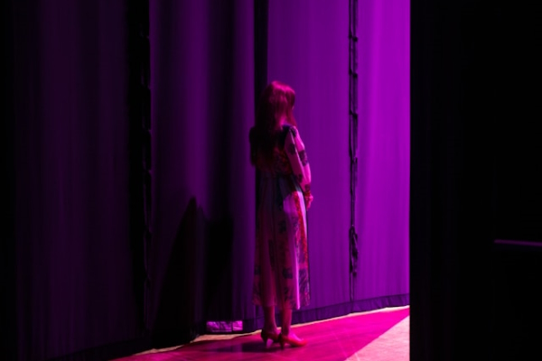 Person waiting in the stage wings. Photo by Sam Spencer on Unsplash