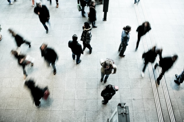 Blurry busy city plaza. Photo by Timon Studler