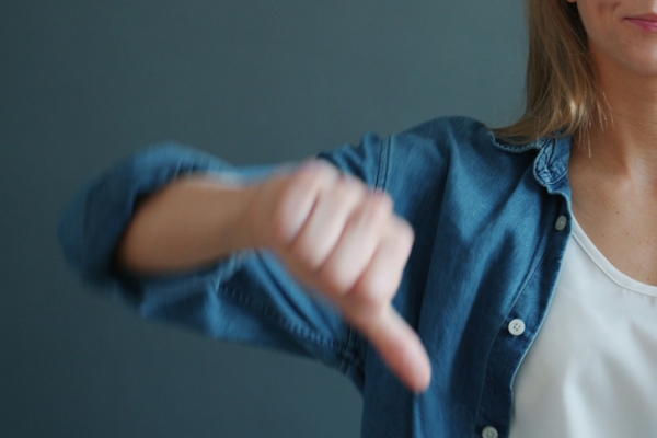 Thumbs down. Photo by Vitaly Gariev on Unsplash.